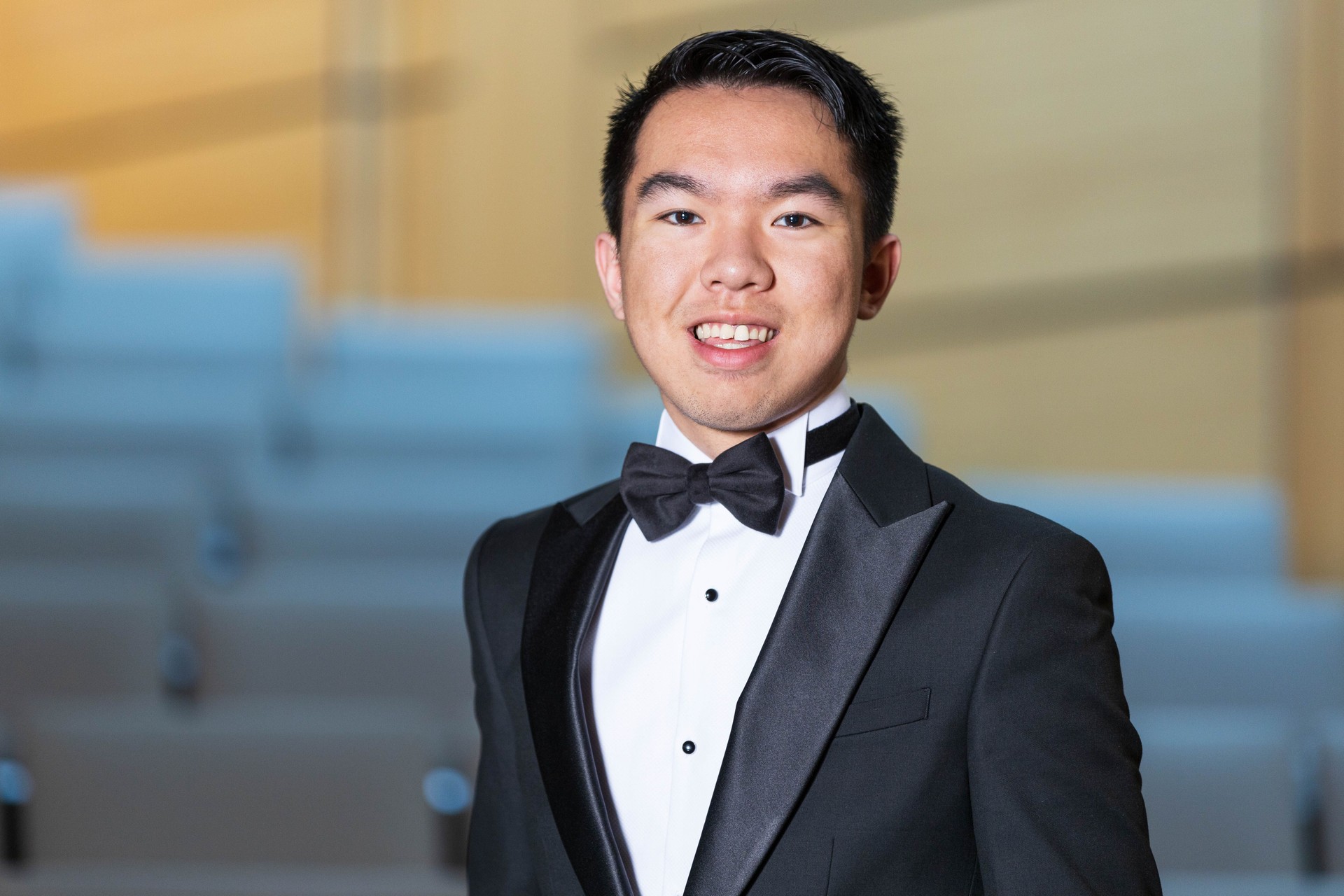 Smiling young man in a tuxedo closeup