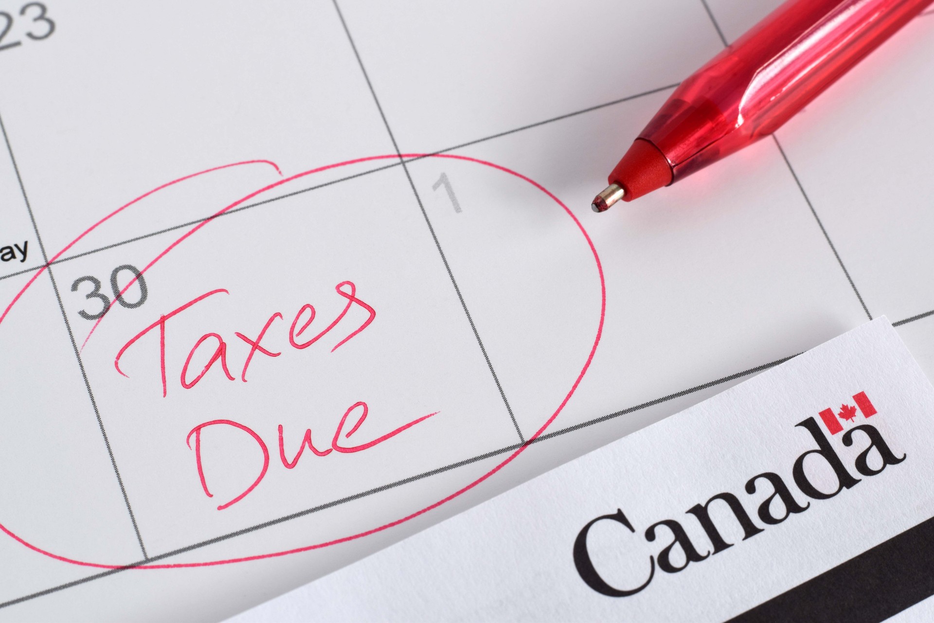 Closeup calendar with circled April 30 date with words Taxes Due to Canada Revenue Agency