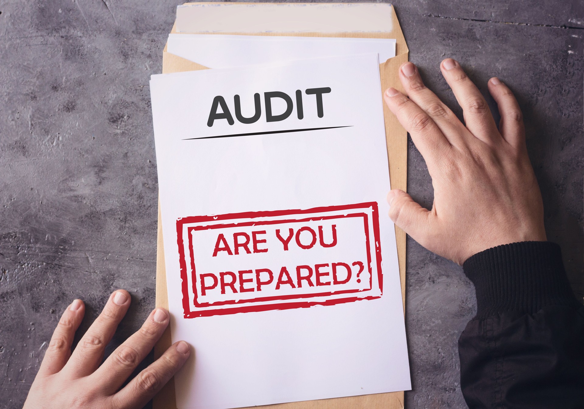Audit Envelope Are You Prepared on white paper an yellow envelope holding by human hands